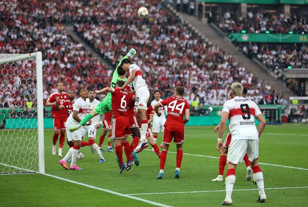 Fussball, Herren, DFB-Pokal Finale, Saison 2025 2026, FC Bayern München - VFB Stuttgart, Olympiastadion Berlin Jonas Urbig (FC Bayern München) im Strafraum in Aktion, Ball wegfausten gegen Chema Andres (VFB Stuttgart) DFB, DFL regulations prohibit any use of photographs as image sequences and or quasi-video