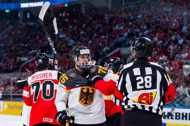 ZURICH, SWITZERLAND - MAY 23: Samuel Dove-MCFalls (Germany, 75) got attacked by an Austrian, separated by Cedric Borga (Referee) during the Preliminary Round - Group A Match 41 between Austria and Germany at the IIHF Ice hockey, Eishockey World Championship, WM, Weltmeisterschaft 2026, Swiss Life Arena on May 23, 2026 in Zurich, Switzerland. Zurich Switzerland Copyright: xTimoxSteinx