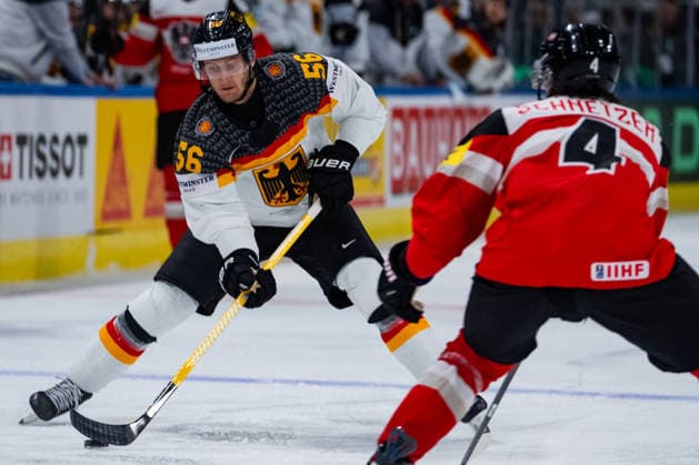ZURICH, SWITZERLAND - MAY 23: Manuel Wiederer (Germany, 56) in the battle for the puck with Ramon Schnetzer (Austria, 4) during the Preliminary Round - Group A Match 41 between Austria and Germany at the IIHF Ice hockey, Eishockey World Championship, WM, Weltmeisterschaft 2026, Swiss Life Arena on May 23, 2026 in Zurich, Switzerland. Zurich Switzerland Copyright: xTimoxSteinx