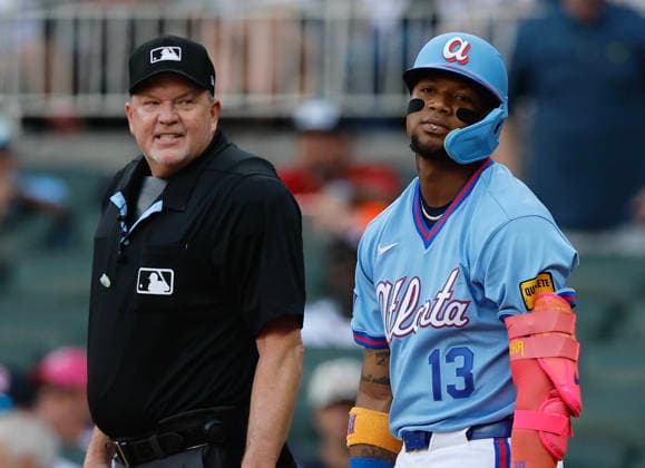 Right fielder Ronald Acuna, Jr. 13 of the Atlanta Braves reacts after a strikeout on a check swing while home plate umpire Ron Kulpa looks on during the game against the Washington Nationals at Truist Park on Saturday, May 23, 2026 in Atlanta, Georgia.  ATL20260523109 MikexZarrilli