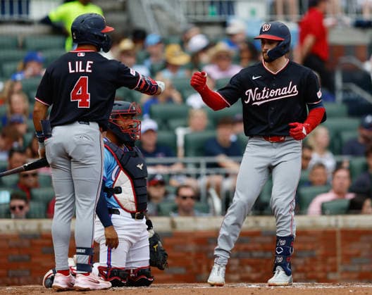 Centerfielder Dylan Crews 3 of the Washington Nationals shakes hands with left fielder Dayton Lile 4 after Crews hit a solo home run in the fourth inning during the game against the Atlanta Braves at Truist Park on Saturday, May 23, 2026 in Atlanta, Georgia.  ATL20260523113 MikexZarrilli
