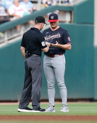 Third base umpire Tom Hanrahan 69 talks with pitcher Brad Lord 41 of the Washington Nationals in the sixth inning during the game against the Atlanta Braves at Truist Park on Saturday, May 23, 2026 in Atlanta, Georgia.  ATL20260523132 MikexZarrilli