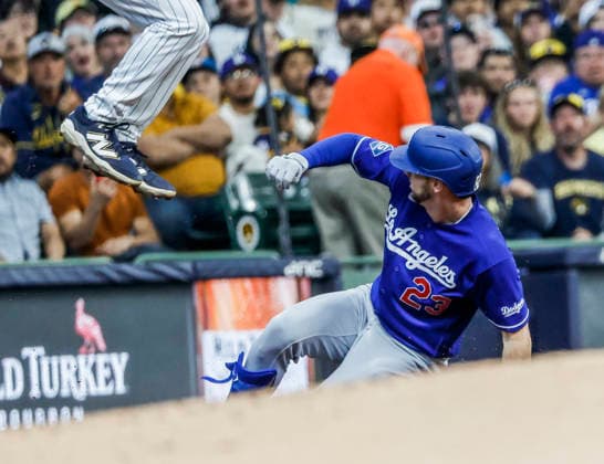 Los Angeles Dodgers right fielder Kyle Tucker slides into third base with a triple under Milwaukee Brewers third baseman David Hamilton in the third inning of the MLB, Baseball Herren, USA game between the Los Angeles Dodgers and the Milwaukee Brewers at American Family Field in Milwaukee, Wisconsin on Saturday, May 23, 2026.  MIL20260523814 TANNENxMAURY