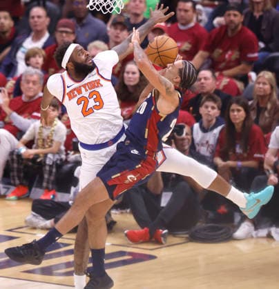 Cleveland Cavaliers Jaylon Tyson (20) scores and is fouled by New York Knicks Mitchell Robinson (23) during the second quarter of their Eastern Conference Final game in Cleveland, Ohio Saturday May 23, 2026.  CLE20260523108 AARONxJOSEFCZYK