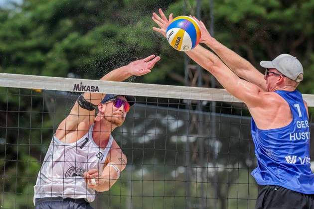 (260524) -- LAGUNA PROVINCE, May 24, 2026 -- Philipp Huster (R) of Germany competes against Adrian Heidrich of Switzerland during the men s semifinal match between Adrian Heidrich Yves Haussener of Switzerland and Philipp Huster Sven Winter of Germany at the Volleyball World Beach Pro Tour Challenge in Laguna Province, the Philippines on May 24, 2026 ) (SP)PHILIPPINES-LAGUNA PROVINCE-VOLLEYBALL WORLD BEACH PRO TOUR CHALLENGE ROUELLExUMALI 