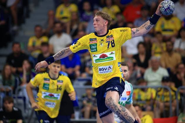 Edwin Aspenbäck ( 78) von den Rhein Neckar Löwen springt in der SAP Arena zum Wurf hoch und hält den Ball mit der rechten Hand. Im Hintergrund ist Mitspieler Gino Steenaerts ( 14) in gelbem Trikot zu sehen. Edwin Aspenbäck ( 78; Rhein Neckar Löwen) beim Wurfversuch