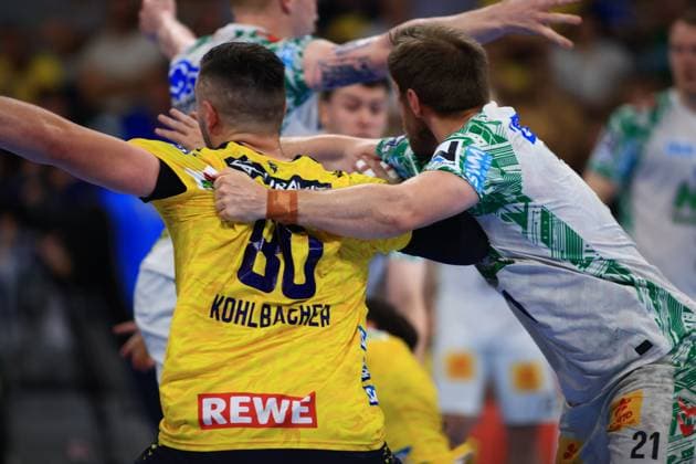 Jannik Kohlbacher ( 80; Rhein Neckar Löwen) im gelben Trikot stemmt sich im Kreisläufer-Duell gegen Albin Lagergren ( 21; SC Magdeburg) im weißen Trikot. Beide Spieler kämpfen intensiv um die Vorherrschaft in der SAP Arena. Jannik Kohlbacher ( 80; Rhein Neckar Löwen) im Zweikampf gegen Albin Lagergren ( 21; SC Magdeburg)
