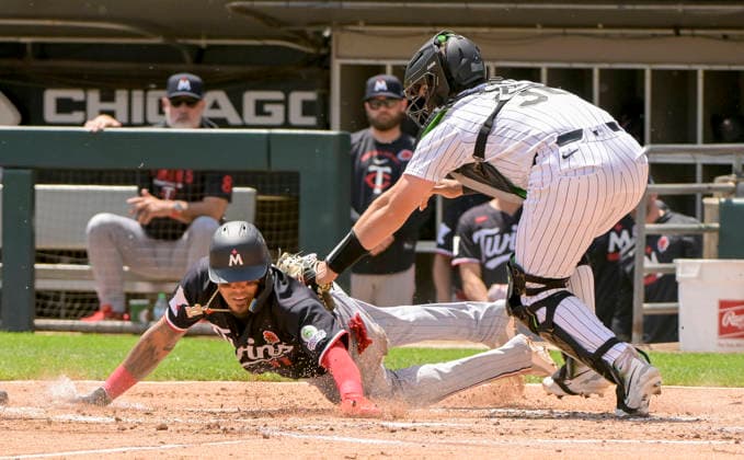 Chicago White Sox catcher Drew Romo (36) makes the tag on Minnesota Twins shortstop Orlando Arcia (11) on a long throw by right fielder Rikuu Nishida during the second inning at Rate Field in Chicago, IL on Monday, May 25, 2026.  CHI20260525114 MARKxBLACK