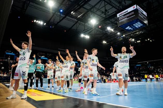 Die Spieler von Frisch Auf Göppingen jubeln nach dem Abpfiff auf dem Spielfeld der Barclays Arena. Die Mannschaft in weißen Trikots präsentiert sich mit erhobenen Armen dem Publikum. Handball Verein Hamburg vs. Frisch Auf Göppingen Copyright: xPhilippHeistx