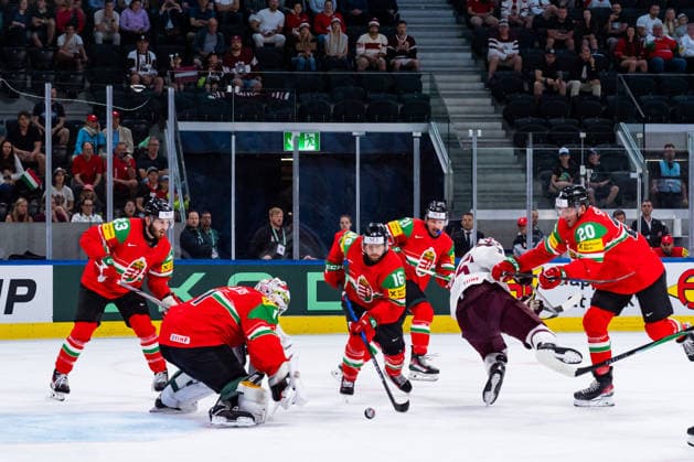 ZURICH, SWITZERLAND - MAY 26: Janos Hari (Hungary, 16) takes the puck in front of Bence Balizs (Hungary, 1) during the Preliminary Round - Group A Match 51 between Hungary and Latvia at the IIHF Ice hockey, Eishockey World Championship, WM, Weltmeisterschaft 2026, Swiss Life Arena on May 26, 2026 in Zurich, Switzerland. Zurich Switzerland Copyright: xTimoxSteinx