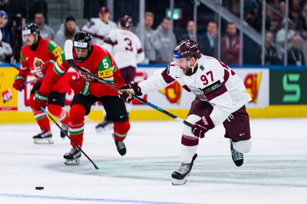 ZURICH, SWITZERLAND - MAY 26: Doman Szongoth (Hungary, 5) in the battle for the puck with Haralds Egle (Latvia, 97) during the Preliminary Round - Group A Match 51 between Hungary and Latvia at the IIHF Ice hockey, Eishockey World Championship, WM, Weltmeisterschaft 2026, Swiss Life Arena on May 26, 2026 in Zurich, Switzerland. Zurich Switzerland Copyright: xTimoxSteinx
