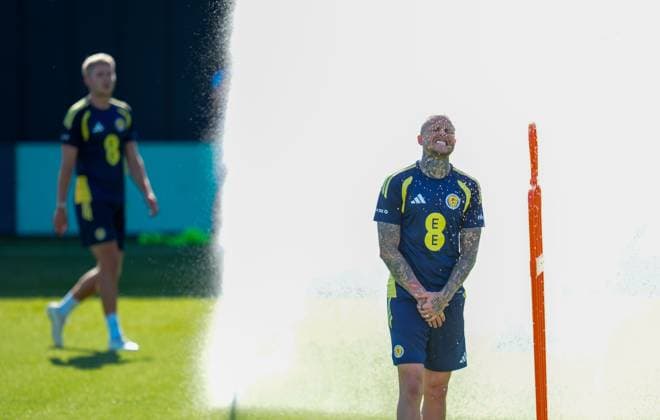 Lyndon Dykes of Scotland cools down under a sprinkler during a training session on a hot afternoon at Lesser Hampden. Scotland Team Training, Football, Hampden Park, Glasgow, Scotland, UK - 26 May 2026Glasgow Hampden Park United Kingdom EDITORIAL USE ONLY No use with unauthorised audio, video, data, fixture lists, club league logos or live services. Online in-match use limited to 120 images, no video emulation. No use in betting, games or single club league player publications.  Copyright: xStuartxWallace Shutterstockx 16898315c