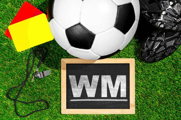 Germany - May 27, 2026: PHOTO MONTAGE, stock photo of the 2026 World Cup - World Cup - Soccer on a grass field next to a chalkboard with the words World Cup. *** FOTOMONTAGE, Symbolfoto Fußball-WM 2026 - Fußball-Weltmeisterschaft - Fußball auf Rasen neben einer Kreidetafel mit dem Schriftzug WM.