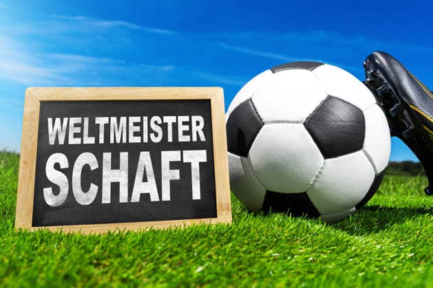 Germany - May 27, 2026: PHOTO MONTAGE, stock photo for the 2026 FIFA World Cup, WM, Weltmeisterschaft, Fussball A soccer ball, red and yellow referee cards, and a whistle lie on green field turf next to a sign bearing the words World Cup. *** FOTOMONTAGE, Symbolfoto zur Fußball-Weltmeisterschaft 2026: Fußball, rote und gelbe Schiedsrichterkarten sowie eine Pfeife liegen auf grünem Spielfeldrasen neben einer Tafel mit dem Schriftzug Weltmeisterschaft.