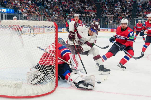 FRIBOURG, SWITZERLAND - MAY 28: Eduards Tralmaks of Latvia 2nd L) against goalkeeper Henrik Haukeland of Norway during the 2026 IIHF Ice hockey, Eishockey World Championship, WM, Weltmeisterschaft Switzerland game between Norway and Latvia at BCF Arena on May 28, 2026 in Fribourg, Fribourg. Fribourg BCF Arena Fribourg Switzerland Copyright: xJustPictures.ch JarixPestelaccix jp-en-EuSpIm-JP6_JAR_Norway_Latvia_28May2026_00131
