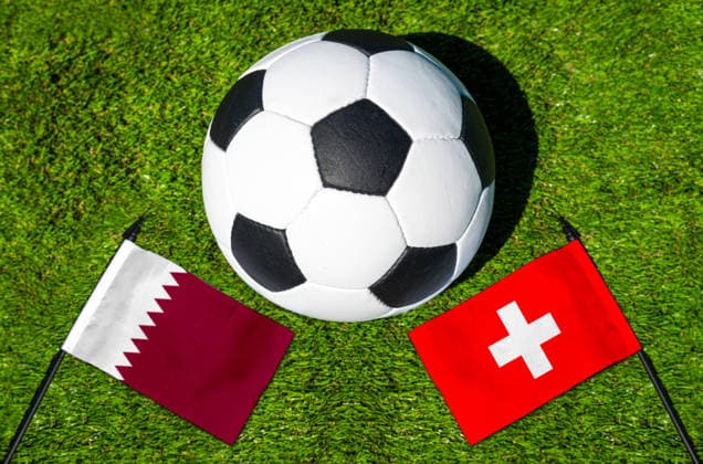 May 22, 2026: PHOTO MONTAGE, 2026 FIFA World Cup, WM, Weltmeisterschaft, Fussball National flags of Qatar and Switzerland with a soccer ball on the field. Stock image for the group stage match on June 13 at the 2026 FIFA World Cup *** FOTOMONTAGE, Fußball-Weltmeisterschaft 2026: Nationalflaggen von Katar und Schweiz mit Fußball auf Rasen. Symbolbild zum WM-Gruppenspiel am 13 Juni bei der FIFA Fussball-Weltmeisterschaft 2026