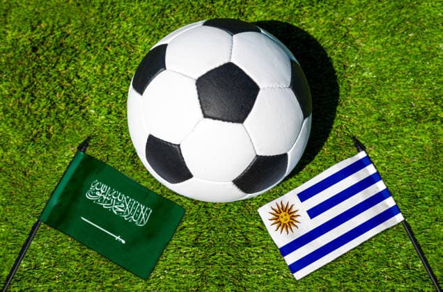 May 22, 2026: PHOTO MONTAGE, 2026 FIFA World Cup, WM, Weltmeisterschaft, Fussball National flags of Saudi Arabia and Uruguay with a soccer ball on the field. Stock image for the group stage match on June 16 at the 2026 FIFA World Cup *** FOTOMONTAGE, Fußball-Weltmeisterschaft 2026: Nationalflaggen von Saudi-Arabien und Uruguay mit Fußball auf Rasen. Symbolbild zum WM-Gruppenspiel am 16 Juni bei der FIFA Fussball-Weltmeisterschaft 2026