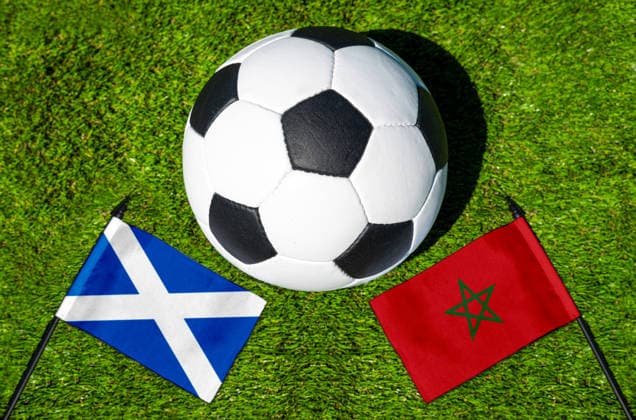 May 22, 2026: PHOTO MONTAGE, 2026 FIFA World Cup, WM, Weltmeisterschaft, Fussball National flags of Scotland and Morocco with a soccer ball on a field. Stock image for the group stage match on June 20 at the 2026 FIFA World Cup *** FOTOMONTAGE, Fußball-Weltmeisterschaft 2026: Nationalflaggen von Schottland und Marokko mit Fußball auf Rasen. Symbolbild zum WM-Gruppenspiel am 20 Juni bei der FIFA Fussball-Weltmeisterschaft 2026