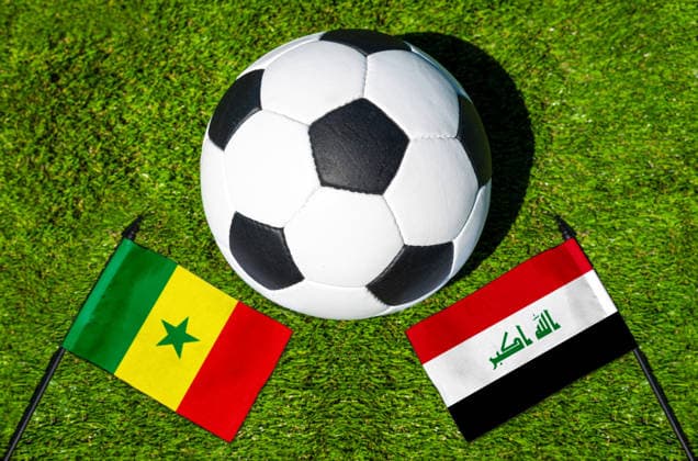 May 22, 2026: PHOTO MONTAGE, 2026 FIFA World Cup, WM, Weltmeisterschaft, Fussball National flags of Senegal and Iraq with a soccer ball on the field. Stock image for the group stage match on June 26 at the 2026 FIFA World Cup *** FOTOMONTAGE, Fußball-Weltmeisterschaft 2026: Nationalflaggen von Senegal und Irak mit Fußball auf Rasen. Symbolbild zum WM-Gruppenspiel am 26 Juni bei der FIFA Fussball-Weltmeisterschaft 2026