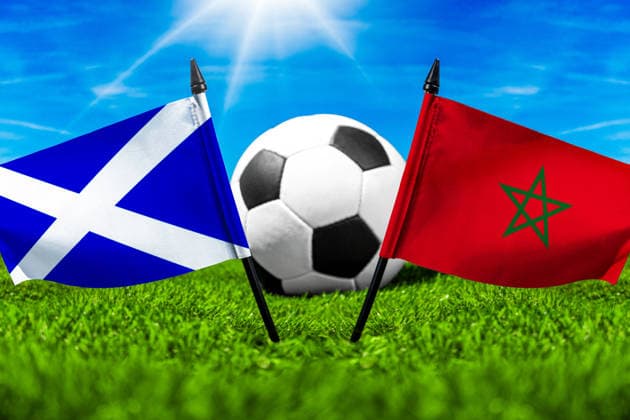 May 22, 2026: PHOTO MONTAGE, 2026 FIFA World Cup, WM, Weltmeisterschaft, Fussball National flags of Scotland and Morocco with a soccer ball on a field. Stock image for the group stage match on June 20 at the 2026 FIFA World Cup *** FOTOMONTAGE, Fußball-Weltmeisterschaft 2026: Nationalflaggen von Schottland und Marokko mit Fußball auf Rasen. Symbolbild zum WM-Gruppenspiel am 20 Juni bei der FIFA Fussball-Weltmeisterschaft 2026