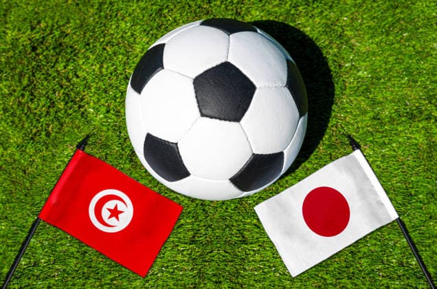 May 22, 2026: PHOTO MONTAGE, 2026 FIFA World Cup, WM, Weltmeisterschaft, Fussball National flags of Tunisia and Japan with a soccer ball on the field. Stock image for the group stage match on June 21 at the 2026 FIFA World Cup *** FOTOMONTAGE, Fußball-Weltmeisterschaft 2026: Nationalflaggen von Tunesien und Japan mit Fußball auf Rasen. Symbolbild zum WM-Gruppenspiel am 21 Juni bei der FIFA Fussball-Weltmeisterschaft 2026