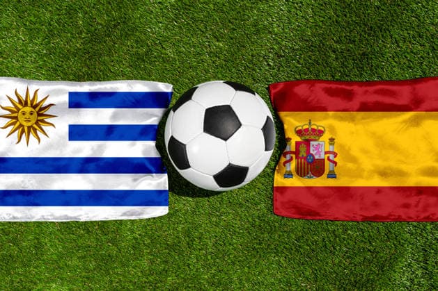 May 22, 2026: PHOTO MONTAGE, 2026 FIFA World Cup, WM, Weltmeisterschaft, Fussball National flags of Uruguay and Spain with a soccer ball on grass. Stock image for the group stage match on June 27 at the 2026 FIFA World Cup *** FOTOMONTAGE, Fußball-Weltmeisterschaft 2026: Nationalflaggen von Uruguay und Spanien mit Fußball auf Rasen. Symbolbild zum WM-Gruppenspiel am 27 Juni bei der FIFA Fussball-Weltmeisterschaft 2026