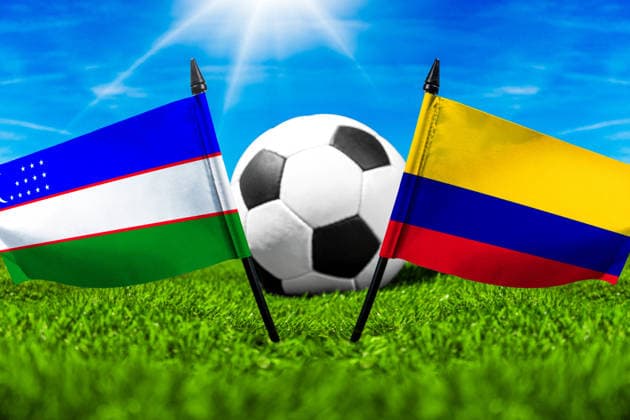 May 22, 2026: PHOTO MONTAGE, 2026 FIFA World Cup, WM, Weltmeisterschaft, Fussball National flags of Uzbekistan and Colombia with a soccer ball on a field. Illustrative image for the group stage match on June 18 at the 2026 FIFA World Cup *** FOTOMONTAGE, Fußball-Weltmeisterschaft 2026: Nationalflaggen von Usbekistan und Kolumbien mit Fußball auf Rasen. Symbolbild zum WM-Gruppenspiel am 18 Juni bei der FIFA Fussball-Weltmeisterschaft 2026