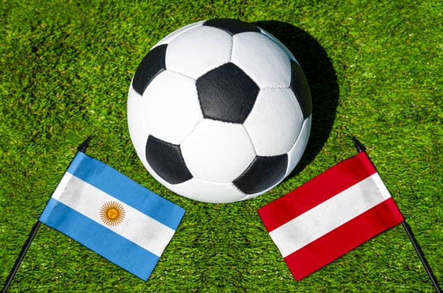 May 22, 2026: PHOTO MONTAGE, 2026 FIFA World Cup, WM, Weltmeisterschaft, Fussball National flags of Argentina and Austria with a soccer ball on the field. Illustrative image for the group stage match on June 22 at the 2026 FIFA World Cup *** FOTOMONTAGE, Fußball-Weltmeisterschaft 2026: Nationalflaggen von Argentinien und Österreich mit Fußball auf Rasen. Symbolbild zum WM-Gruppenspiel am 22 Juni bei der FIFA Fussball-Weltmeisterschaft 2026