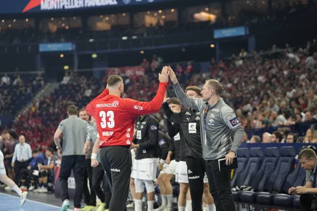 Andreas Wolff ( 33; THW Kiel) klatscht mit einem Betreuer oder Trainer an der Seitenlinie ab. Im Hintergrund sind weitere THW-Kiel-Offizielle und Spieler auf der Bank zu sehen. EHF European League: THW Kiel - Montpellier HB, 30.05.2026, Hamburg, Barclays Arena Copyright: xPhilippHeistx