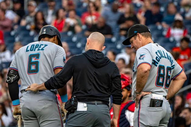 Miami Marlins short-stop Otto Lopez (6) talks to a trainer and Manager Clayton McCullough (86) after being hit with a ball in the top of the second inning during a game against the Washington Nationals at Nationals Park in Washington, DC on Monday, June 1, 2026.  WAP20260601405 BONNIExCASH