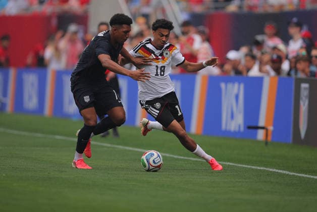 CHICAGO, IL - JUNE 06: Jamal Musiala 10 of Germany and Nathaniel Brown 18 of Germany battle for the ball during a friendly match on June 6, 2026 at Soldier Field in Chicago, Illinois. (Photo by Melissa Tamez Icon Sportswire) SOCCER: JUN 06 USA vs Germany EDITORIAL USE ONLY Icon260606003