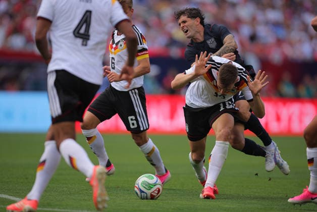 CHICAGO, IL - JUNE 06: Nico Schlotterbeck 15 of Germany tackles Christian Pulisic 10 of the United States during a friendly on June 6, 2026 at Soldier Field in Chicago, Illinois. (Photo by Melissa Tamez Icon Sportswire) SOCCER: JUN 06 USA vs Germany EDITORIAL USE ONLY Icon260606021