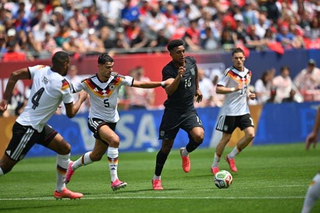 CHICAGO, IL - JUNE 06: Germany defensive midfielder Aleksandar Pavlovic (5) and United States midfielder Cristian Roldan (15) battle for the ball during a friendly match between the United States and Germany on June 6, 2026, at Soldier Field in Chicago, IL. (Photo by Patrick Gorski Icon Sportswire) SOCCER: JUN 06 USA vs Germany EDITORIAL USE ONLY Icon260606021