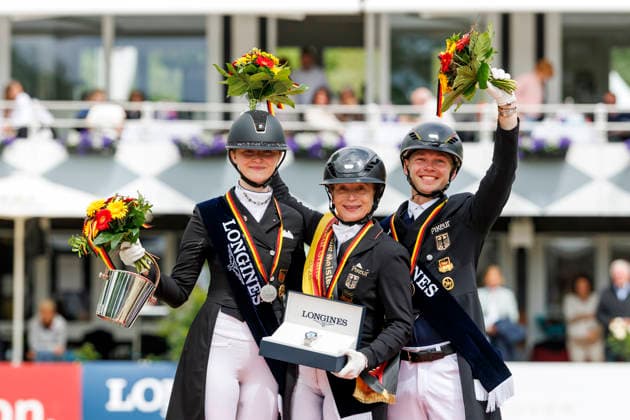BALVE - LONGINES Balve Optimum 2026, BALVE - LONGINES Balve Optimum 2026 WERTH Isabell (GER), ROTHENBERG Semmieke (GER), NETZ Raphael (GER) Meisterehrung Sektdusche Deutsche Meisterschaften Dressur Grand Prix Kür 2026 - Grand Prix Kür Freestyle LONGINES GROSSER OPTIMUM PREIS 2026 präsentiert von der MEGGLE Group GmbH Dressurprüfung Kl.S
