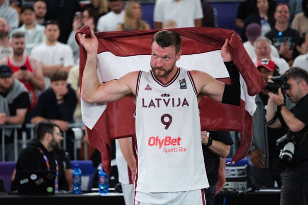 June 7, 2026, Warsaw, Masovian Voivodeship, Poland: Latvia s ZIGMARS RAIMO (9) holds up a Latvian flag over his shoulders in victory at the end of the FIBA 3x3 Basketball World Cup men s final game between Latvia and Germany in Warsaw, Poland. Latvia defeated Germany to become world champions. Basketball 2026: FIBA 3x3 World Cup Men s Final: Latvia 20:15 Germany  - ZUMAk204 20260607_zip_k204_063 Copyright: xRomanxKozielx