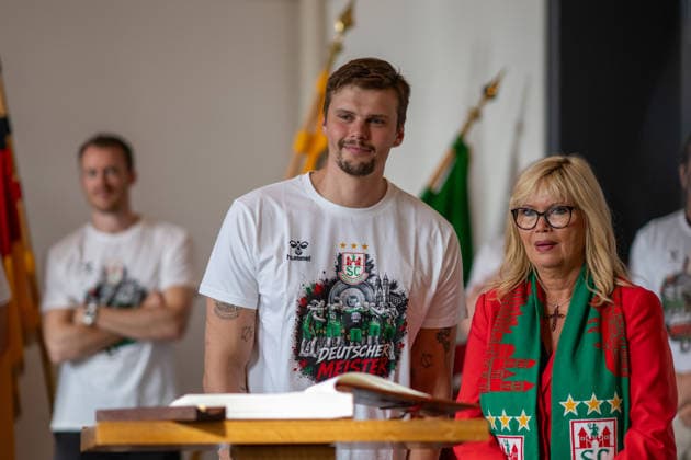 Deutschland: HBL DAIKIN Handball Bundesliga 2025 - 2026, Empfang im Rathaus und Meisterfeier des SC Magdeburg - Alter Markt (Magdeburg): Sergey Hernandez Ferrer (SC Magdeburg, 1) bei der Eintragung in das Goldene Buch der Landeshauptstadt Magdeburg