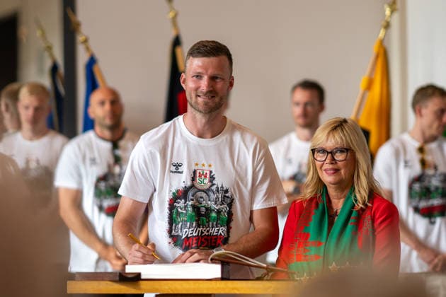 Deutschland: HBL DAIKIN Handball Bundesliga 2025 - 2026, Empfang im Rathaus und Meisterfeier des SC Magdeburg - Alter Markt (Magdeburg): Philipp Weber (SC Magdeburg, 20) bei der Eintragung in das Goldene Buch der Landeshauptstadt Magdeburg