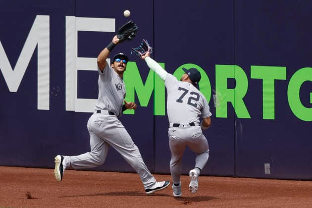 New York Yankees Trent Grisham (12) makes a catch against the Cleveland Guardians in the first inning as he collides with Jose Caballero (72) at Progressive Field in Cleveland, Ohio on Wednesday, June 10, 2026.  CLE20260610109 AARONxJOSEFCZYK