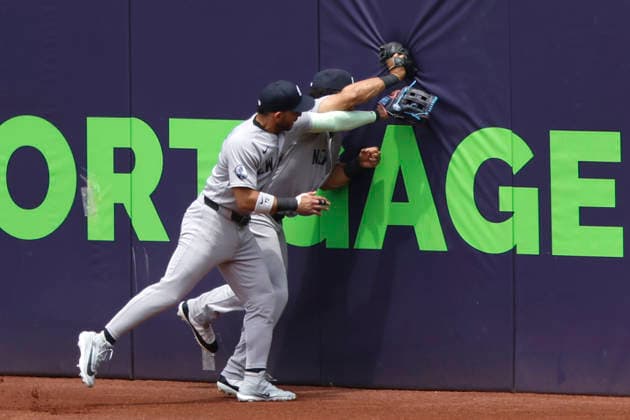 New York Yankees Trent Grisham (12) makes a catch against the Cleveland Guardians in the first inning as he collides with Jose Caballero (72) at Progressive Field in Cleveland, Ohio on Wednesday, June 10, 2026.  CLE20260610110 AARONxJOSEFCZYK