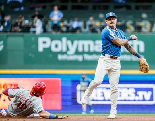 Milwaukee Brewers shortstop Joey Ortiz (R) forces out Philadelphia Phillies designated hitter Kyle Schwarber (L) and turns a double play on Philadelphia Phillies first baseman Bryce Harper in the fourth inning of the MLB, Baseball Herren, USA game between the Philadelphia Phillies and the Milwaukee Brewers at American Family Field in Milwaukee, Wisconsin on Friday, June 12, 2026.  MIL20260612816 TANNENxMAURY