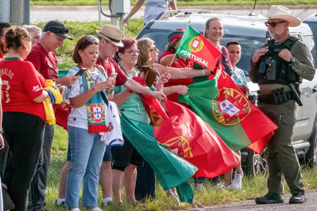 June 12, 2026, West Palm Beach, Fl, USA: Fans wearing Portugal colors gather with flags as law enforcement manages crowds near Palm Beach International Airport during the national team, Nationalteam ¢â‚¬â ¢s World Cup arrival. West Palm Beach USA - ZUMAc343 0859032279st Copyright: xChrisxBeckettx