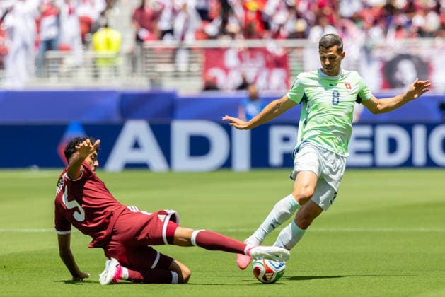SANTA CLARA, CA - JUNE 13: Jassem Gaber 5 of Qatar challenges Remo Freuler 8 of Switzerland for the ball during the FIFA World Cup, WM, Weltmeisterschaft, Fussball 2026 Group B match between Qatar and Switzerland on June 13, 2026 at San Francisco Bay Area Stadium in Santa Clara, CA. (Photo by Matthew Huang Icon Sportswire) SOCCER: JUN 13 FIFA World Cup 26 Group B - Qatar vs Switzerland EDITORIAL USE ONLY Icon260613009