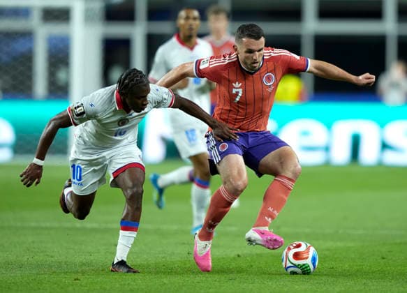 (260614) -- BOSTON, June 14, 2026 -- John McGinn (R) of Scotland vies with Jean-Ricner Bellegarde of Haiti during the group C match between Haiti and Scotland at the 2026 FIFA World Cup, WM, Weltmeisterschaft, Fussball at Boston Stadium in Boston, the United States, June 13, 2026. ) (SP)U.S.-BOSTON-FOOTBALL-FIFA WORLD CUP-GROUP C-HTI VS SCO ChenxYichen 
