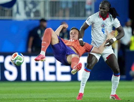 (260614) -- BOSTON, June 14, 2026 -- Lawrence Shankland (L) of Scotland and Ricardo Ade of Haiti compete during the group C match between Haiti and Scotland at the 2026 FIFA World Cup, WM, Weltmeisterschaft, Fussball at Boston Stadium in Boston, the United States, June 13, 2026. ) (SP)U.S.-BOSTON-FOOTBALL-FIFA WORLD CUP-GROUP C-HTI VS SCO ChenxYichen 
