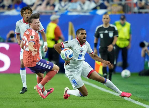 (260614) -- BOSTON, June 14, 2026 -- Nathan Patterson (L) of Scotland and Yassin Fortune of Haiti compete during the group C match between Haiti and Scotland at the 2026 FIFA World Cup, WM, Weltmeisterschaft, Fussball at Boston Stadium in Boston, the United States, June 13, 2026. ) (SP)U.S.-BOSTON-FOOTBALL-FIFA WORLD CUP-GROUP C-HTI VS SCO ChenxYichen 