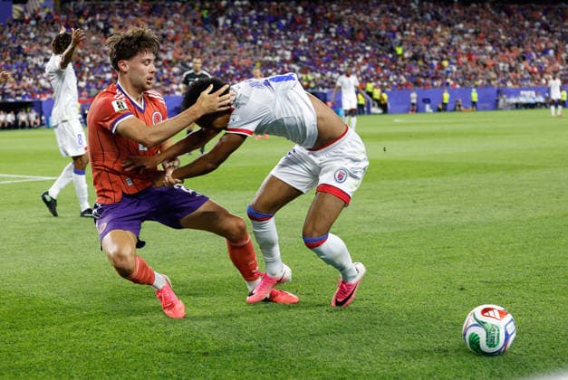 FOXBOROUGH, MA - JUNE 13: Aaron Hickey 2 of Scotland pulls Ruben Providence 15 of Haiti to the ground during the FIFA World Cup, WM, Weltmeisterschaft, Fussball 2026 Group C match between Haiti and Scotland on June 13, 2026, at Boston Stadium in Foxborough, MA. (Photo by M. Anthony Nesmith Icon Sportswire) SOCCER: JUN 13 FIFA World Cup 26 Group C - Haiti vs Scotland EDITORIAL USE ONLY Icon26061315