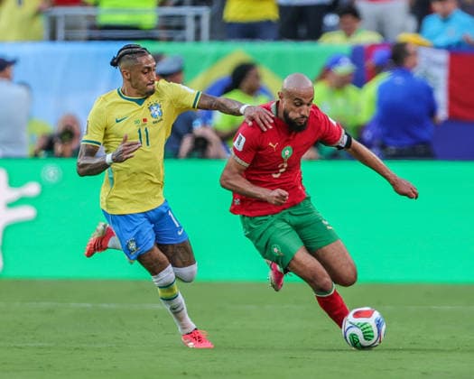 June 14, 2026, East Rutherford, New Jersey, USA: Brazil forward RAPHINHA (11) tries to defend Morocco defender NOUSSAIR MAZRAOUI (3) during the 2026 FIFA World Cup, WM, Weltmeisterschaft, Fussball match between Brazil and Morocco at MetLife Stadium in East Rutherford, NJ East Rutherford USA - ZUMAr225 20260614_zsp_r225_005 Copyright: xScottxRausenbergerx