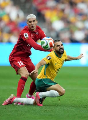 (260614) -- VANCOUVER, June 14, 2026 -- Mert Muldur (L) of T¨¹rkiye and Aziz Behich of Australia compete during the group D match between Australia and T¨¹rkiye at the 2026 FIFA World Cup, WM, Weltmeisterschaft, Fussball at BC Place Vancouver in Vancouver, Canada, June 13, 2026. ) (SP)CANADA-VANCOUVER-FOOTBALL-FIFA WORLD CUP-GROUP D-AUS VS TUR MengxYongmin 