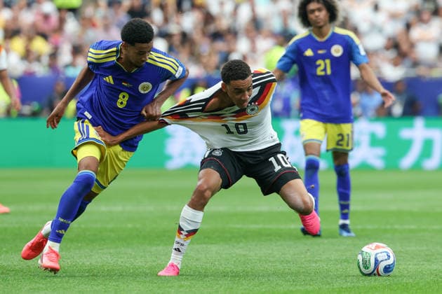 HOUSTON, TX - JUNE 14: Jamal Musiala 10 of Germany has his jersey pulled by Livano Comenencia 8 of Curacao during the FIFA World Cup, WM, Weltmeisterschaft, Fussball 2026 Group E match between Germany and Curacao on June 14, 2026, at Houston Stadium in Houston, Texas. (Photo by David Buono Icon Sportswire) SOCCER: JUN 14 FIFA World Cup 26 Group E - Germany vs Curacao EDITORIAL USE ONLY Icon260614026