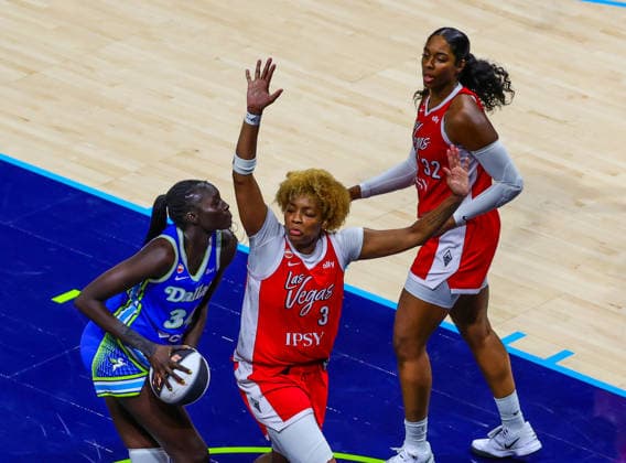 June 15, 2026, Arlington, Texas, USA: ARLINGTON, TX : Dallas Wings forward Awak Kuier (34) eyes the basket as Las Vegas Aces forward Nalyssa Smith (3) and Las Vegas Aces forward Cheyenne Parker-Tyus (32) defend during their Commissioner CupÃ¢â‚¬â ¢s game at College Park Center in Arlington on Wednesday night. Arlington USA - ZUMAm257 20260615_zsp_m257_018 Copyright: xBrianxMcLeanx